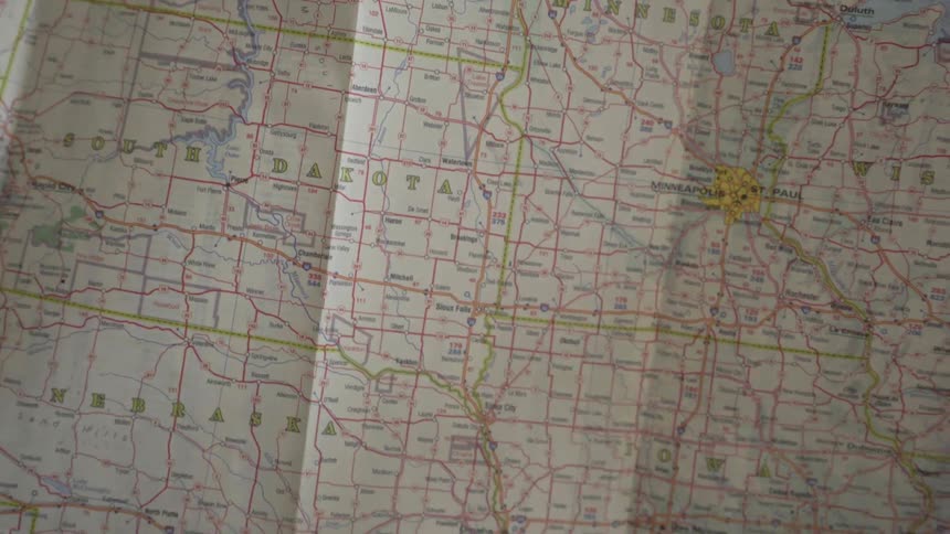 Someone opens a map of the united states
