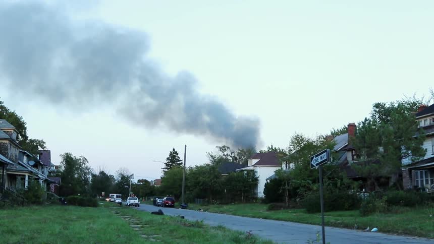 Smoke emerges from a house in a residential area