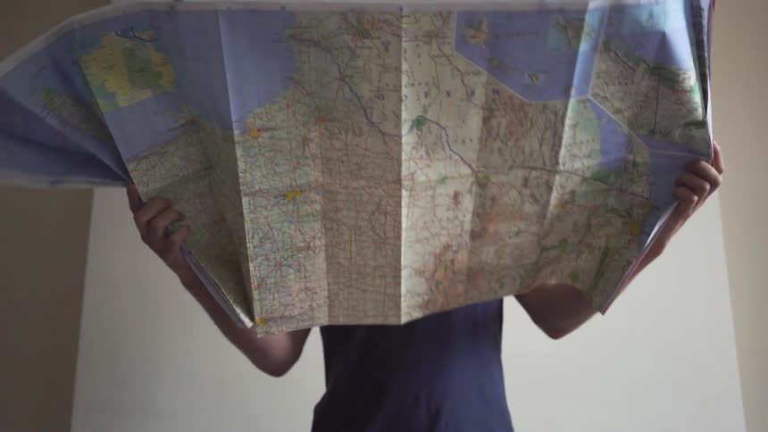 A man holds a large map