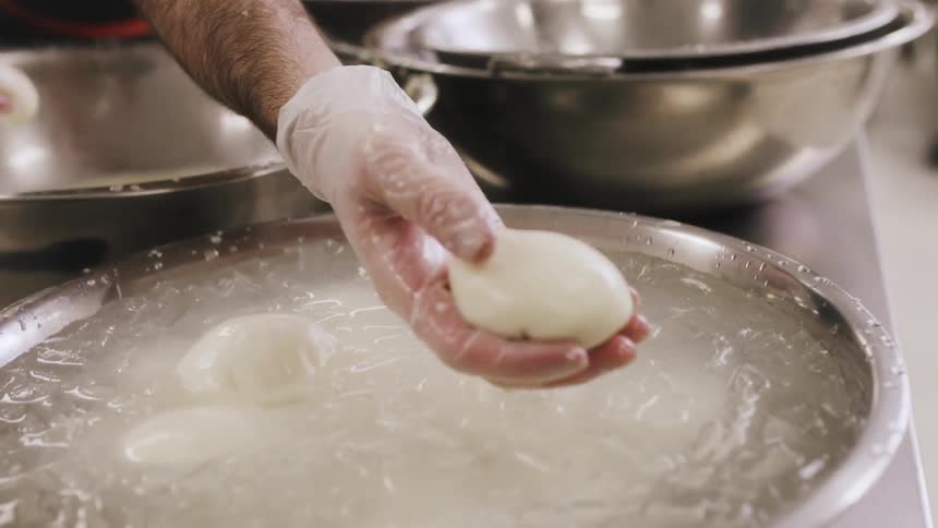 A man is placing dough in an ice bath