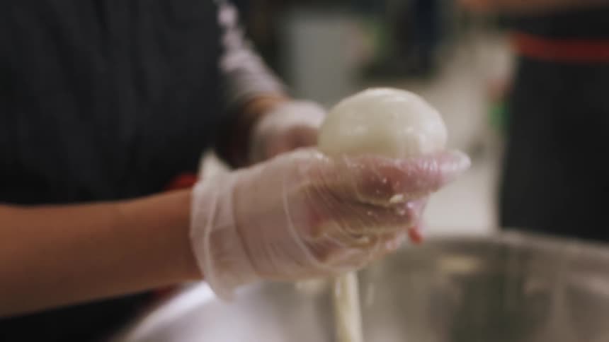 Chefs mold dough in steel bowls
