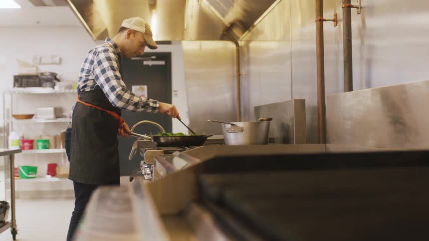 A chef is preparing foot at the oven