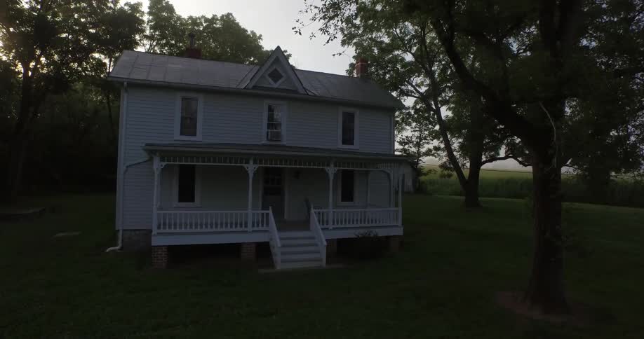 House sitting on a field in a forest