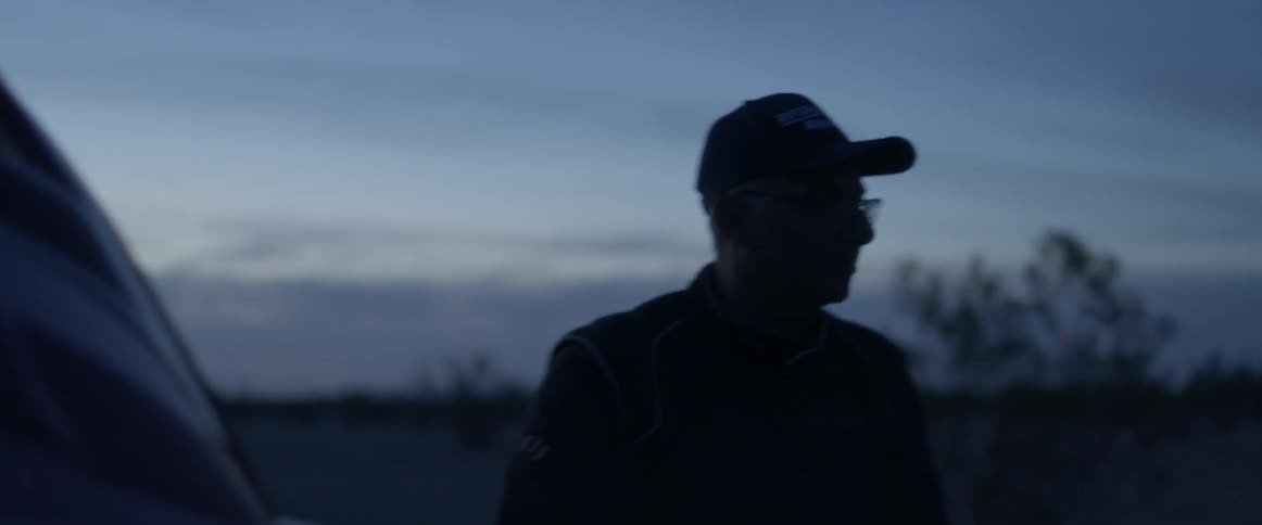 Man walks outside in the country at sunset