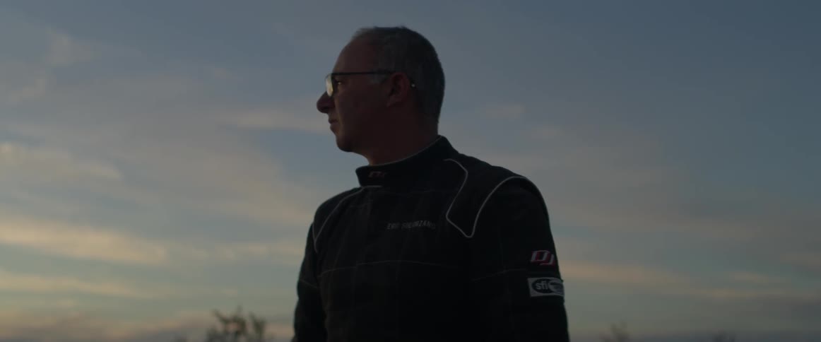 A man looks over to the side at dawn