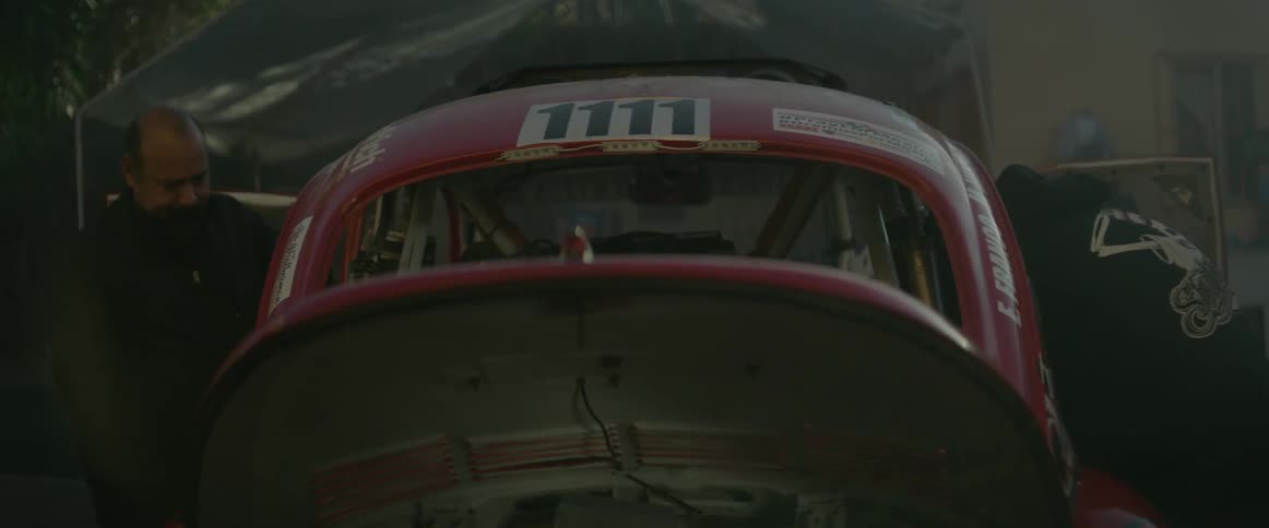 Two men are working on an off-road race vehicle