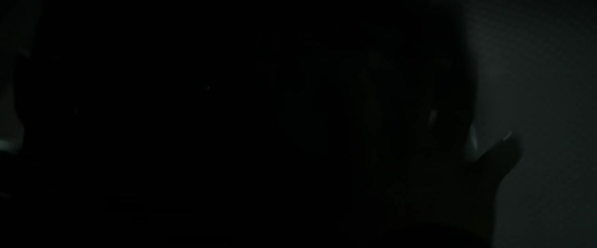 A person is moving a dark room