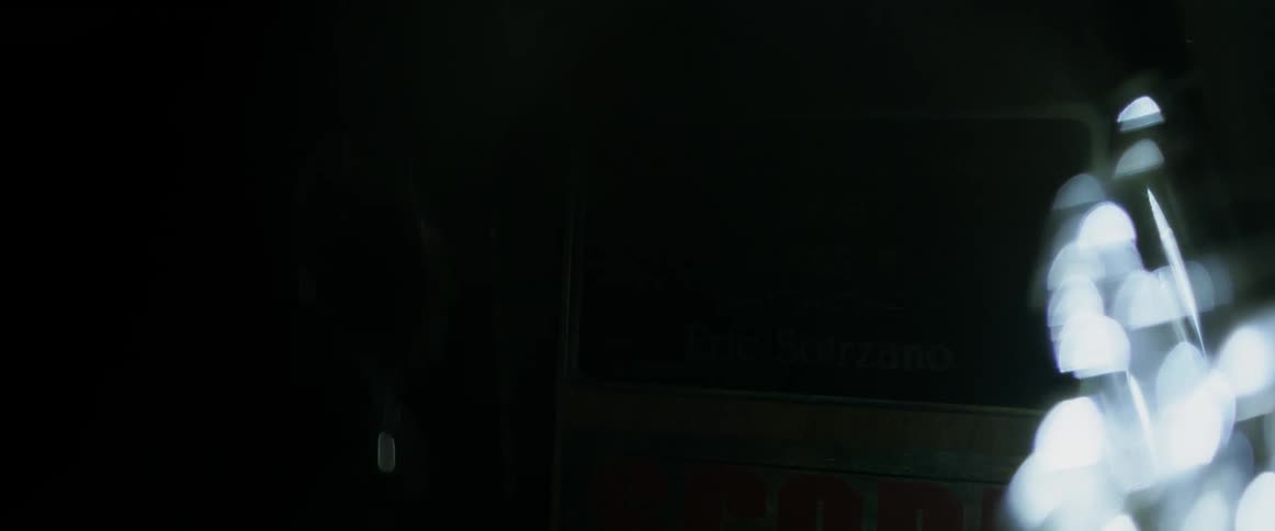 Spinning light momentarily illuminating a sign each time it completes a cycle