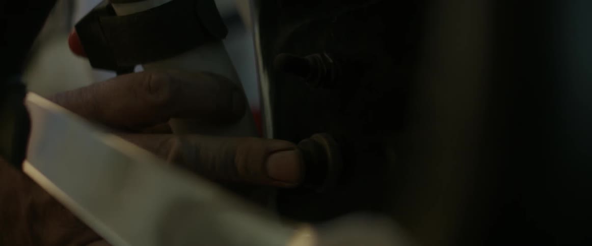 A person presses the button on the side of the panel