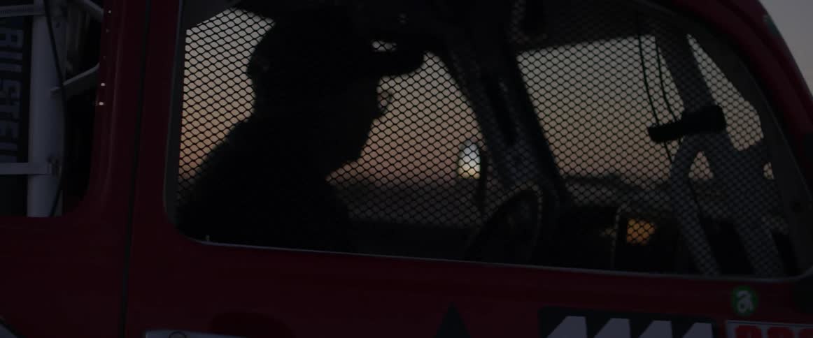 A man driving a truck at night