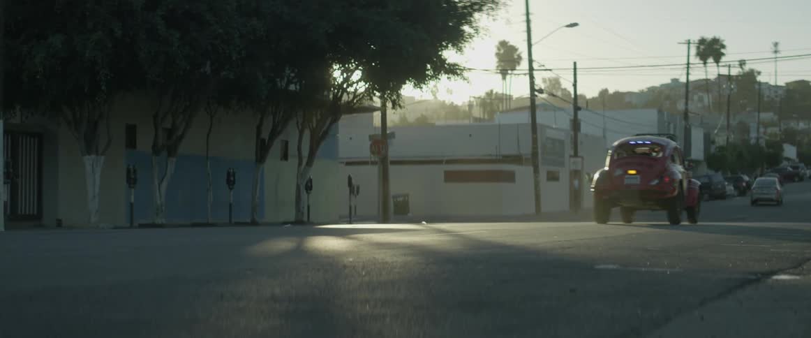 A car is driving down an urban road