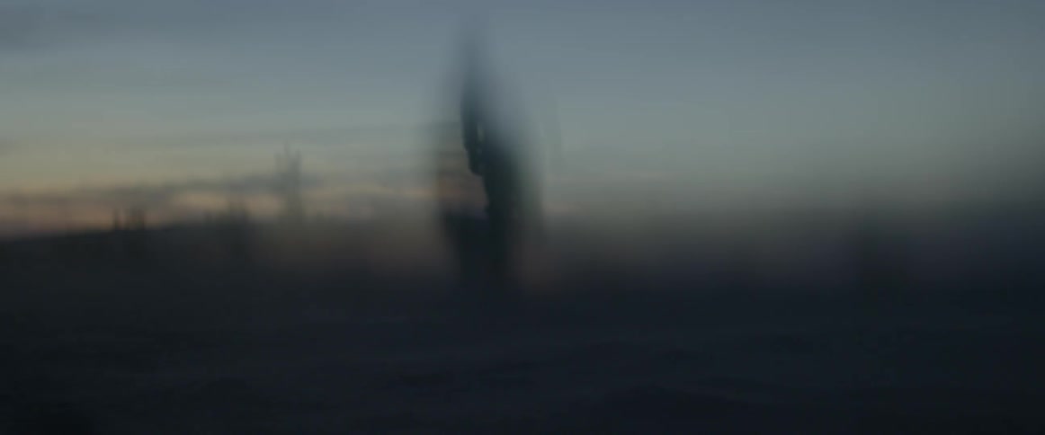 A blurry view of a man walking away