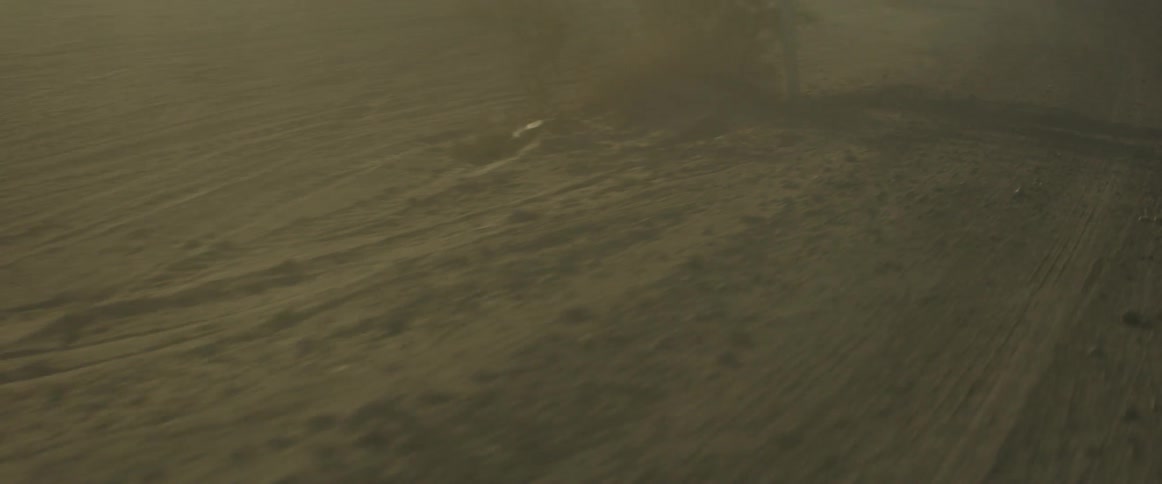 Dust blows up from the ground under a blue sky