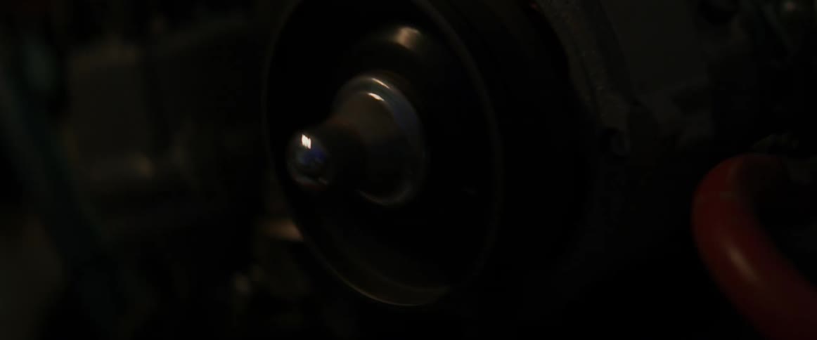 The engine has a belt spinning in the dark