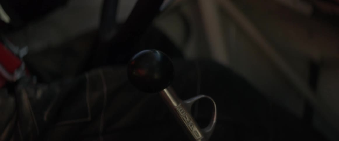 Man pulls shifter sitting inside of a truck