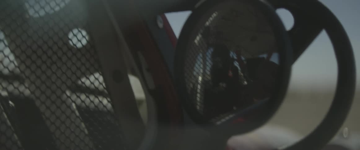 A race driver steers as he races a vehicle