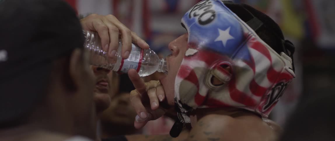 A person drinking water out of a bottle