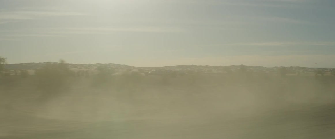 The desert is foggy and full of small hills