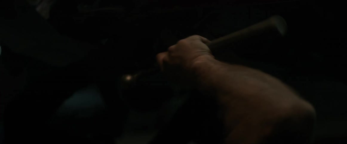 A man works on the undercarriage of a car