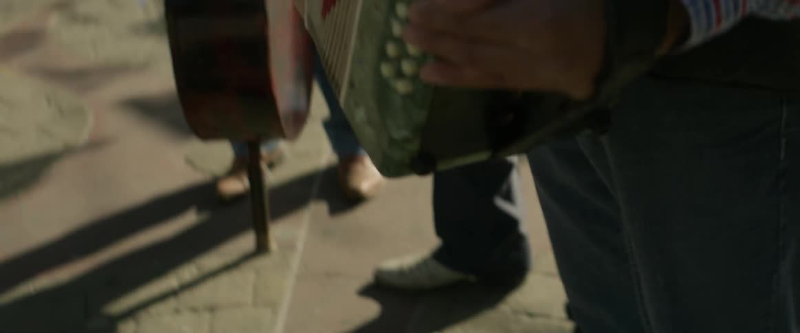 A man plays an accordion outside