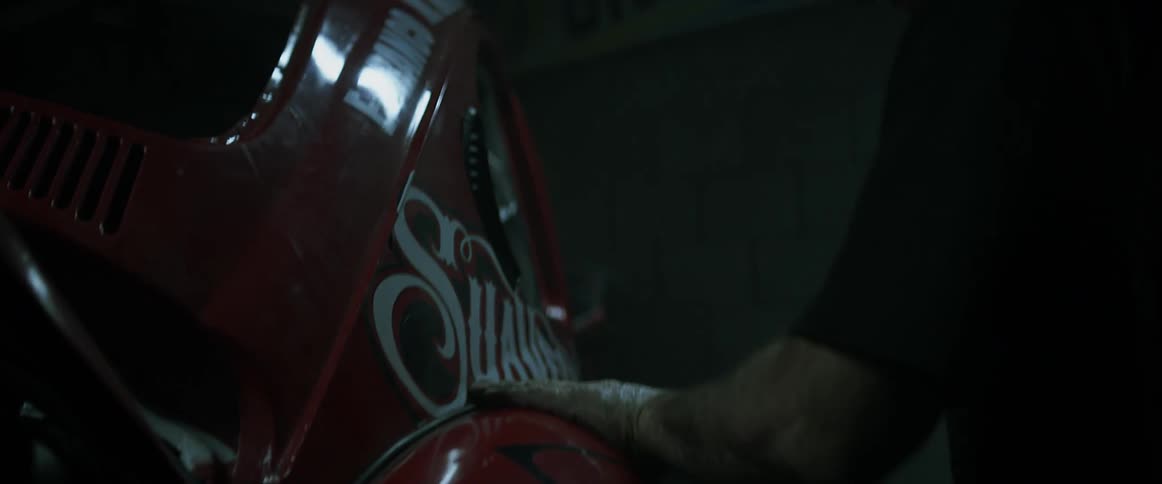 A man rubs his hand on a rally car