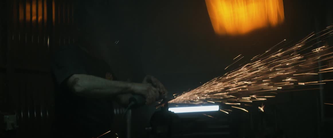 A man is shaving metal with a circular saw