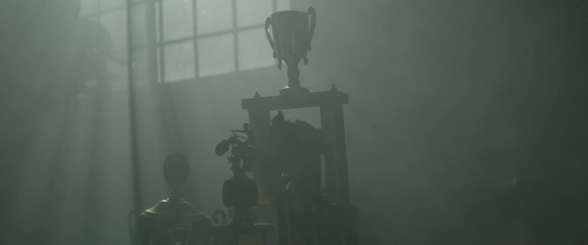 Dust scatters in a room with trophies