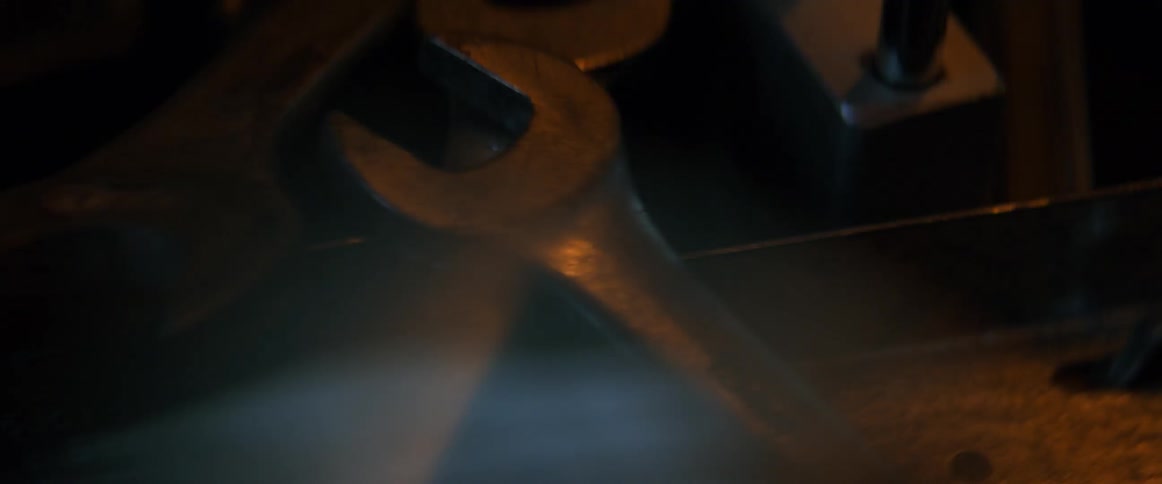 Light reflects on wrenches and tools