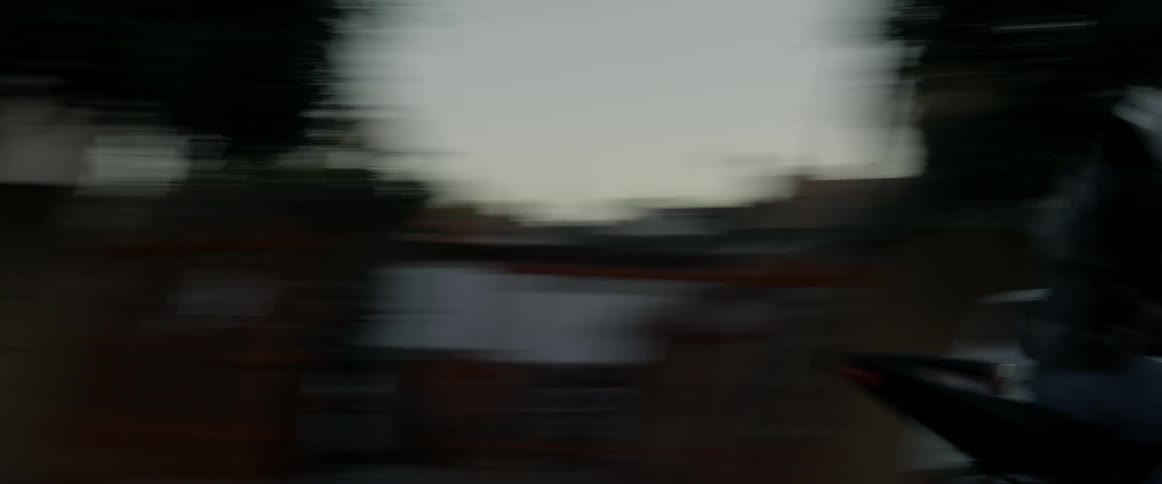 A person speeds by on a motorcycle