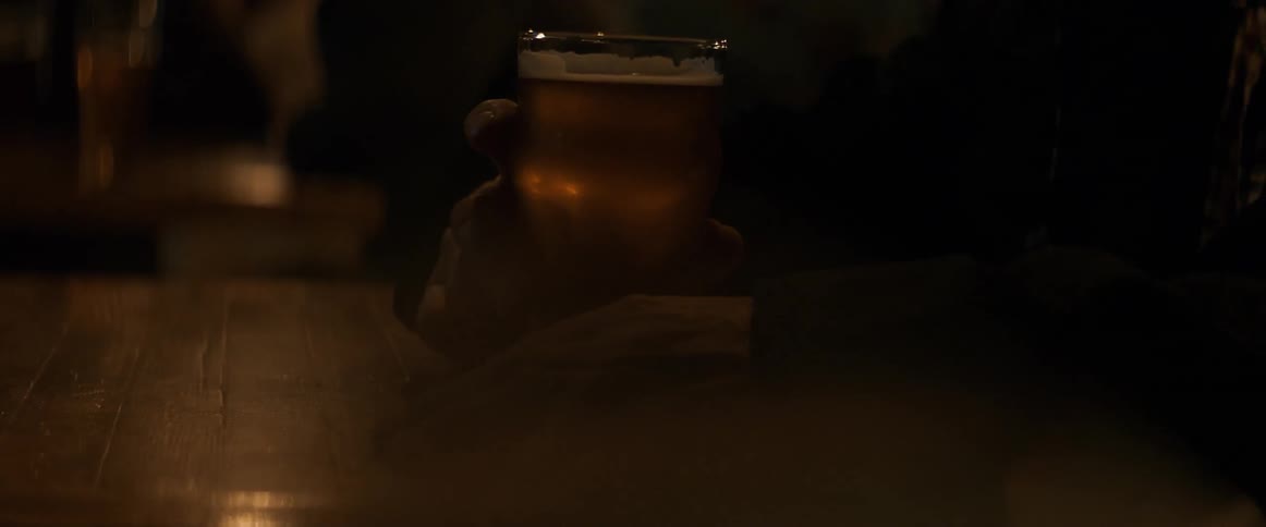 A man holds a cup of beer