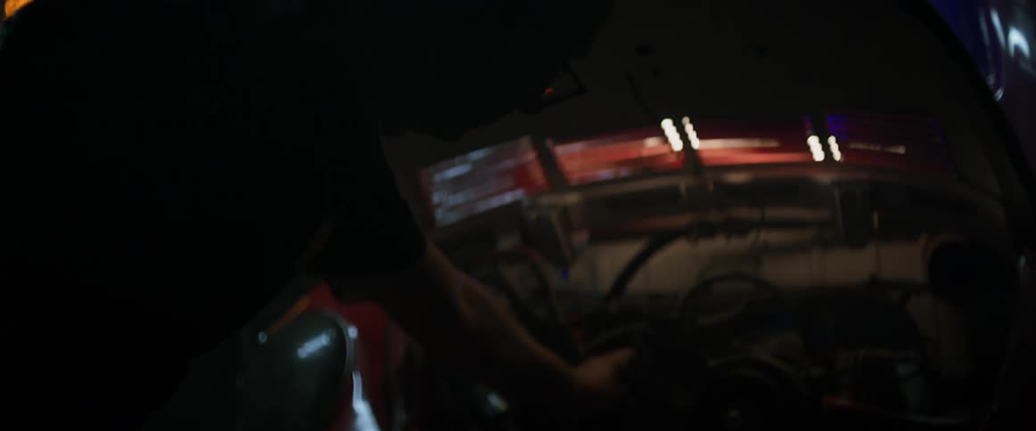 A man works under the hood of a car