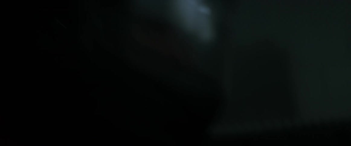Light reflects on the visor of a race driver's helmet