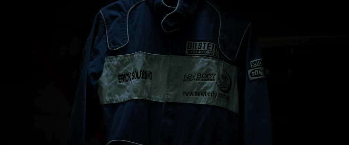 A racing suit rotates on a hanger