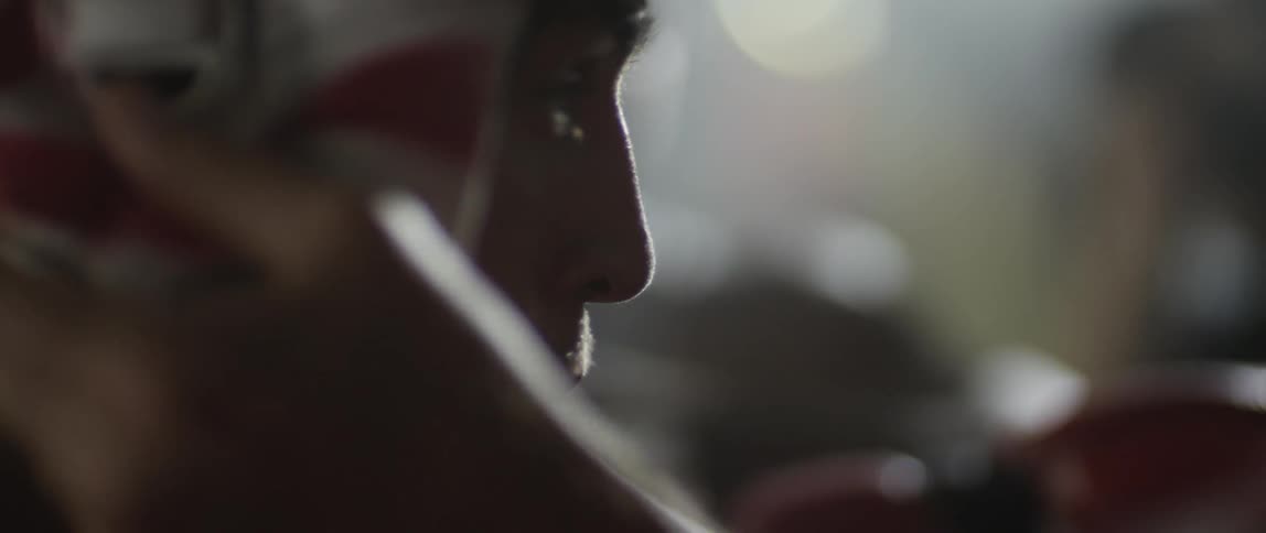 Close up of a boxer taking his head gear off