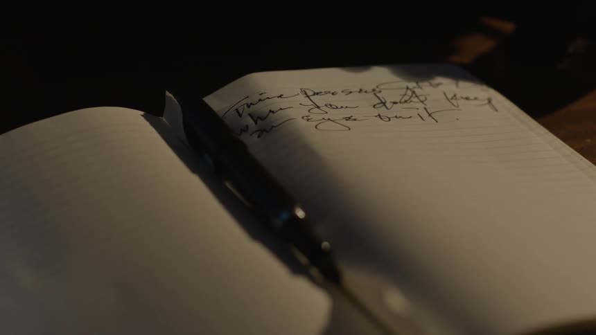 A notebook with a pen inside it
