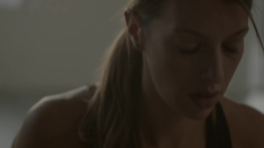 A woman stands indoors