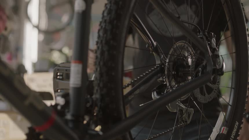 A man fixes a bicycle in a bike shop