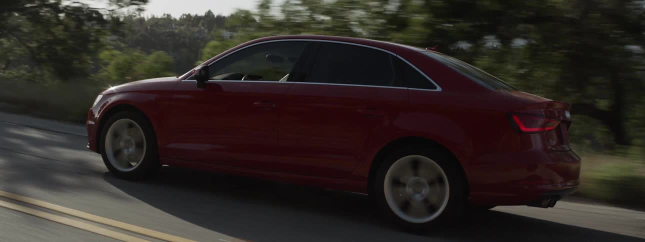 Red car travels down the highway