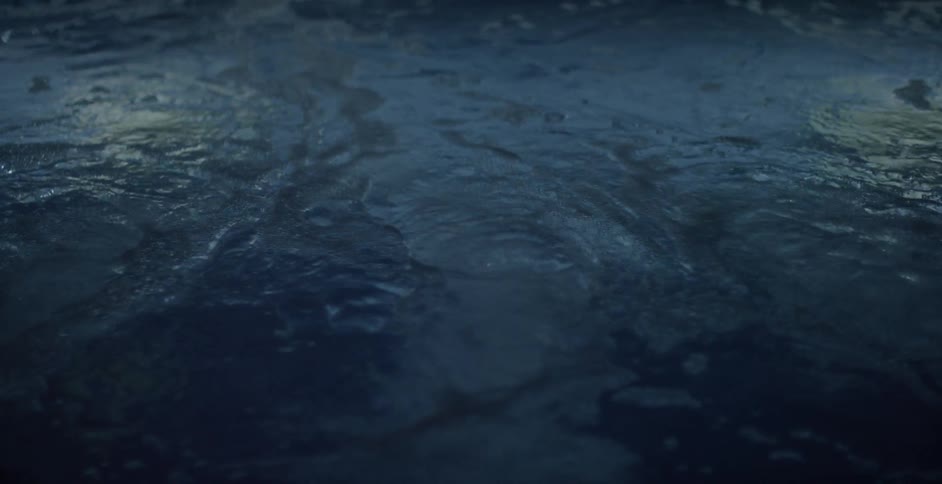 The surface of a body of water ripples and flows