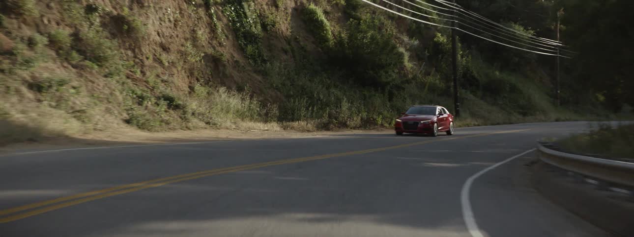 A car drives on a rural road