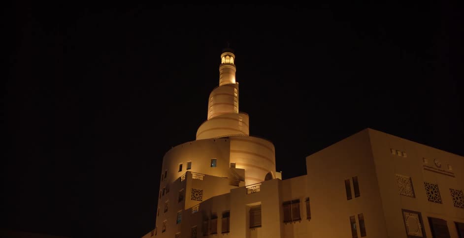 A white building is lit up at night