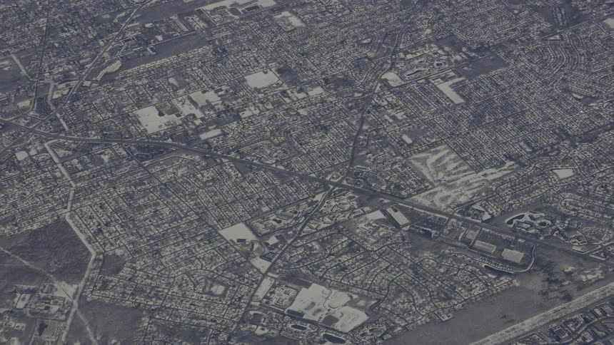 An aerial view of a city with roads and buildings