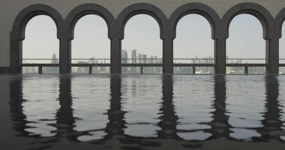 Water ripples in front of arches in a city