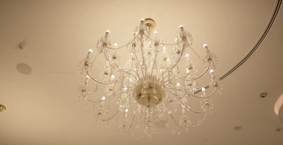 A fancy chandelier hangs from a ceiling