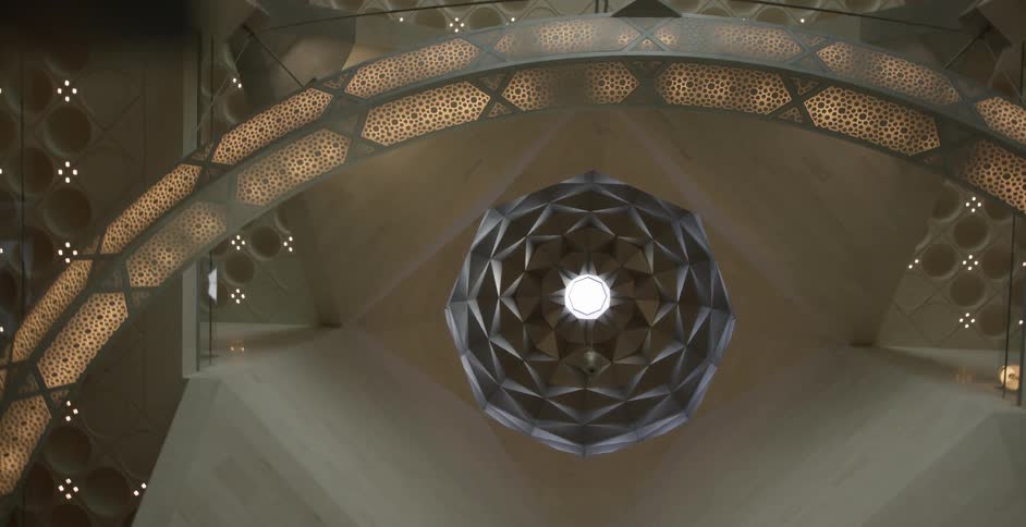 An ornate honeycomb chandelier hangs from the ceiling