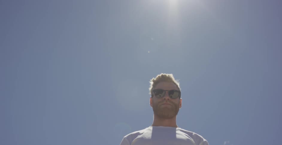 Sunlight shines down on a man in sunglasses