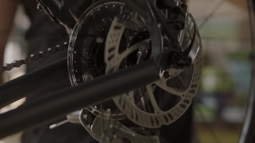 A man spins a bicycle tire