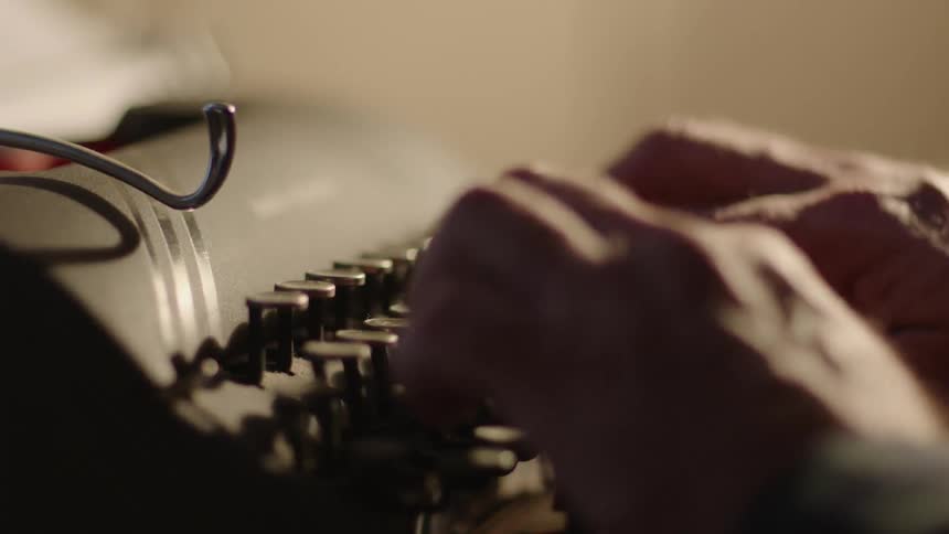 A man is using a typewriter