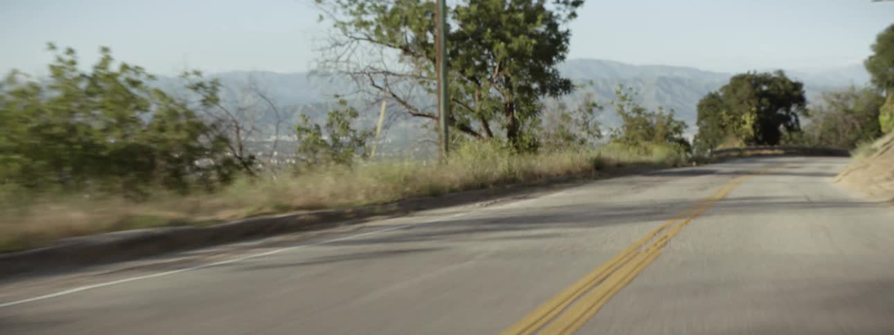 A car drives on a rural road