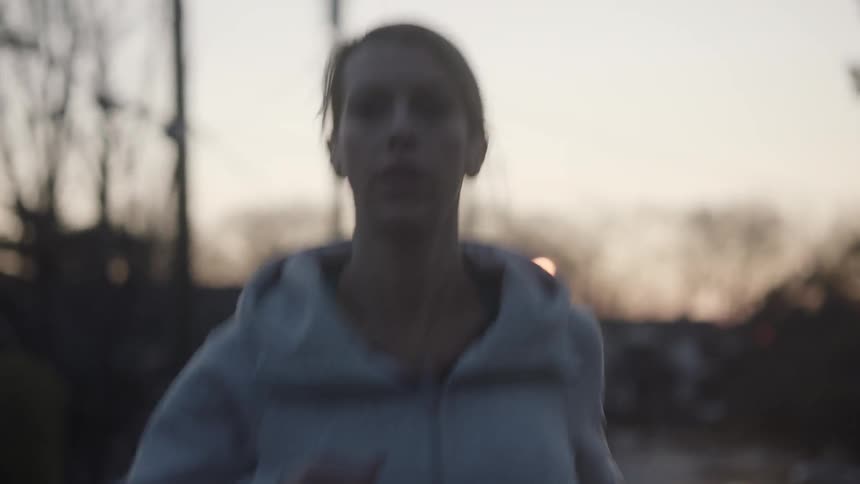 A woman in a jacket jogs outside